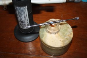The dab tool atop the mixing jar